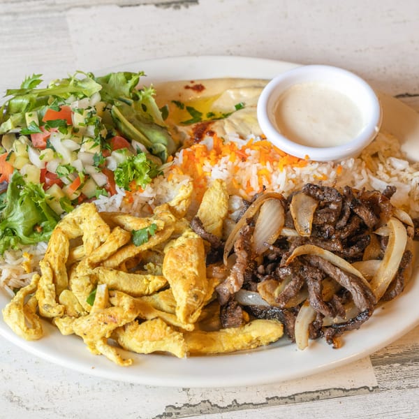 Baba Pita's Mediterranean plate with chicken, beef, rice, salad, hummus, and sauce.